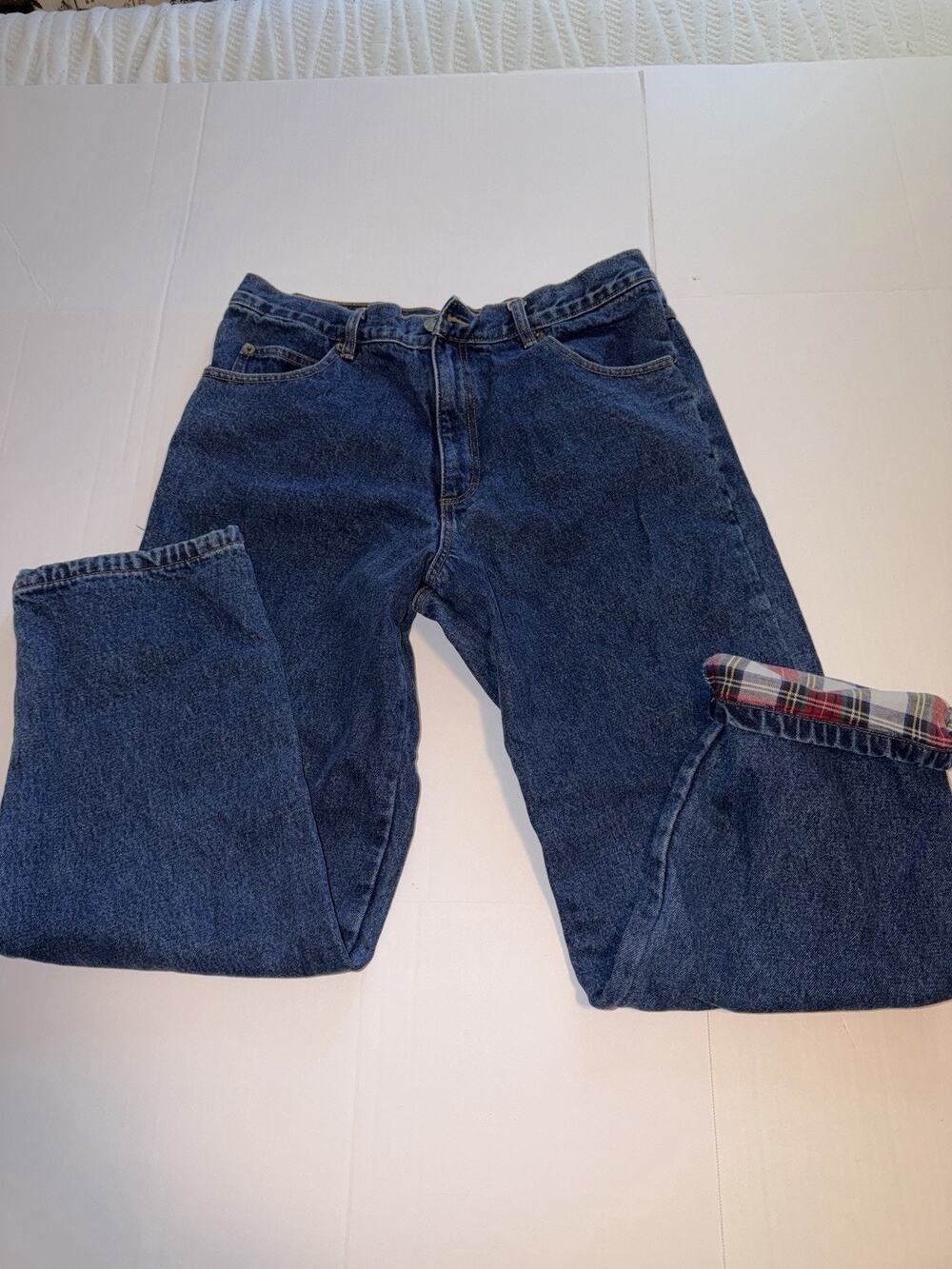 Guide Gear flannel-lined denim jeans featuring a red plaid pattern.